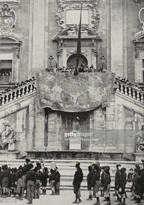  Benito Mussolini watches a parade of the fascist youth organization Opera Nazionale Balilla and syn