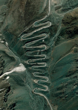 dailyoverview:  Los Caracoles Pass, or The Snails Pass, is a twisting mountain road located in a remote section of the Andes Mountains on the Chilean side of the border with Argentina. The path climbs to an elevation of 10,419 feet, has no roadside safety