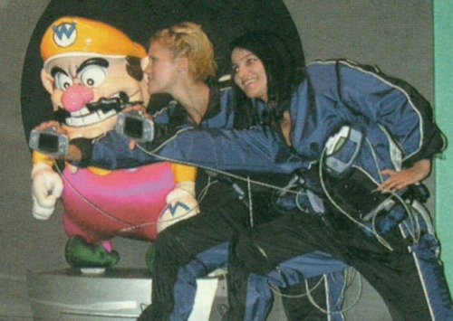 suppermariobroth: Nintendo presenters showing off the Game Boy Advance next to a Wario animatronic a