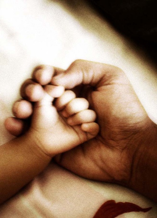 Father and daughter holding hands