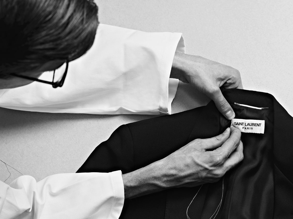 fashion-icons:Yves Saint Laurent sewing the label on a smoking jacket ...