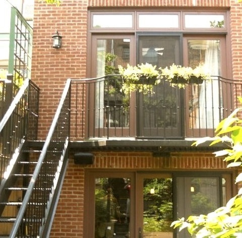 Brick - Transitional ExteriorMedium-sized Transitional Tan Three-story Brick Image With A Flat Roof