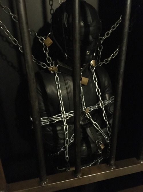 seabondagesadist:  Straitjacket and cell storage. The boy wanted to make me happy. Nothing makes me happier than a boy in heavy bondage, leathered and chained up in the cell for awhile… 😈😈😈 