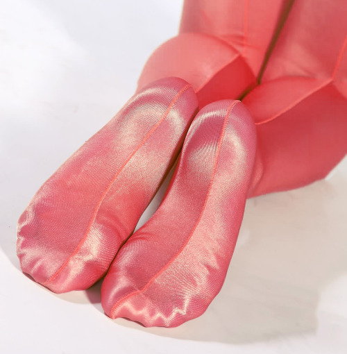 Feet in pink shiny opaque pantyhose