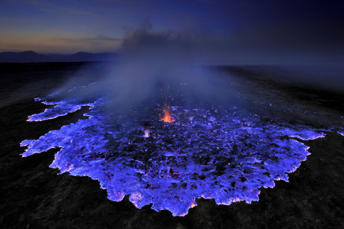 Blue Lava Erupting From The Kawah Ijen Volcano In Indonesia. The Mountain Contains Large Amounts Of Pure