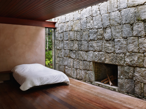 letsbuildahome-fr:  House in Rio Bonito by Carla Juaçaba Four steel beams puncture walls so as to allow a sliver of glazing to wash the interior of the stone walls with diffused light. The visual weight of the rustic stone counters the lightness of