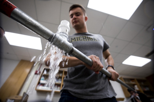 Alexander Hoppe, CoE First-Year Student, tests pipe sensors built for ENG 100: Smart Water Systems i