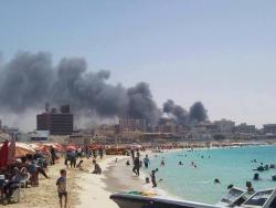 Yassanova:  Egyptians At The Beach As The City Burns In The Background. Absolutely