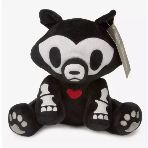 A stuffed animal of a black wolf with a white skeleton. The bones are cartoony and simple. There is a small red heart in the middle of its chest. It has a small black tag on the ear, but the writing is too small to read.