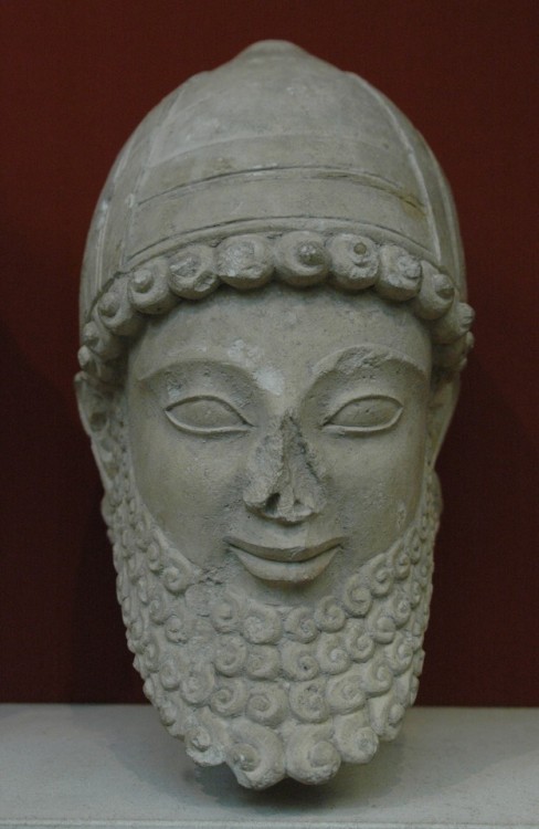 Limestone head from the statue of a worshiper of Apollo, bearded and wearing a helmet with upturned 