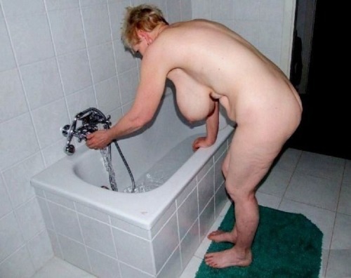 Here granny is getting ready for a bath. adult photos