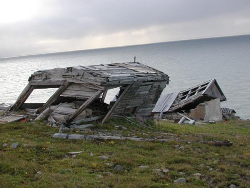 Soviet buildings in the abandoned village of Naukan in MechigmanskiyBay, Cape Drezhnev (Siberia, Rus