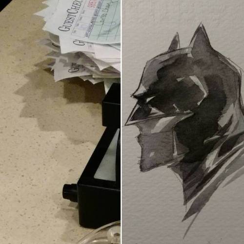 shadow on pile of receipts at dinner looking like my Batman profile shot.