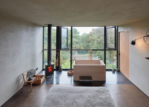 Good wood - I mean, what an awesome idea… a wooden bathtub in a loft extension overlooking a 