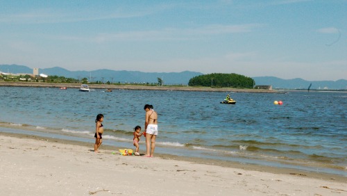 Family plays on the beach at Gamagori, Japan