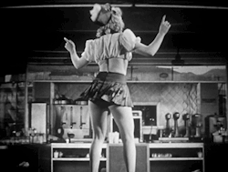 publicdomaindiva:A car hop waitress shakes it in “Gags and Gals,” a 1940s program of “soundies” or musical shorts, from Official Films. 