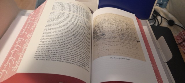 a photo of a lord of the rings book, open, showing one of the illustrations inside