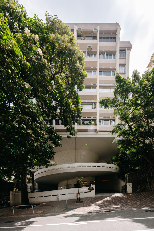 Standing on a round, typically brutalist car ramp, which accesses and structurally supports the buil