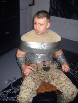 tapegaggedboy:  Restrained, beaten and then humiliated as his captor poured beer all over him, the soldier can only wonder how much longer this will continue.
