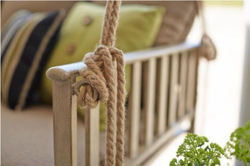 We love this Hampton Bay patio swing available now at HomeDepot.com. The faux wood finish and rope t