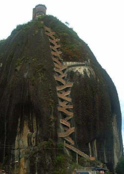 sixpenceee:  La Piedra Del Peñol is a monolithic formation located in Antioquia, Colombia. A viewing spot was built on top of the rock, where it is possible to acquire handicrafts, postcards, and other local goods. There are a total of 740 steps