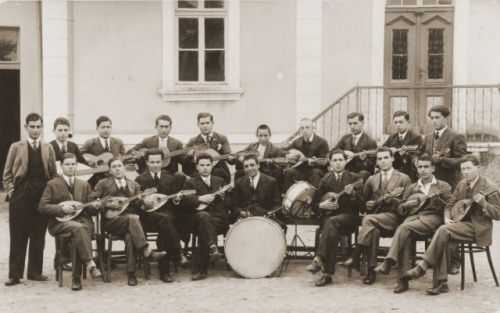 A group of Macedonian Jewish youth who are members of a mandolin band, pose outside a building in Bi