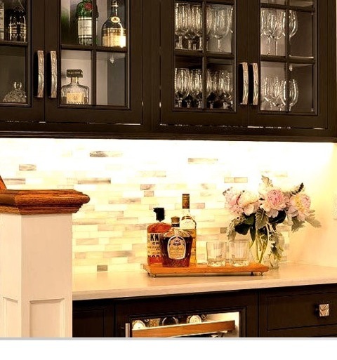 Home Bar U-Shape With Flat-panel Cabinets, White Cabinets, Quartz Countertops, A White Backsplash, And