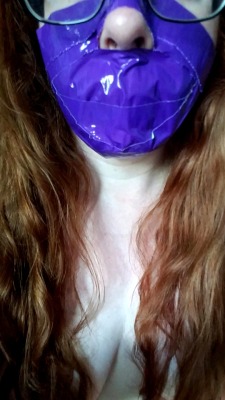 manic-pixie-ginger-slut:  Thoroughly silenced with a tape muzzle. Haven’t woen a tape gag in ages and it feels amazing. Can’t speak, can’t relax my jaw. Can’t stop the puddle growing between my legs…