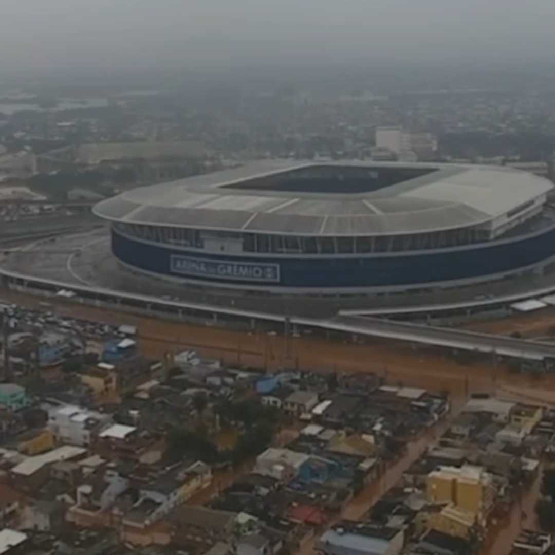 Picture taken in Porto Alegre. A drone view of a soccer stadium and the nearby neighborhood. The neighborhood is flooded.