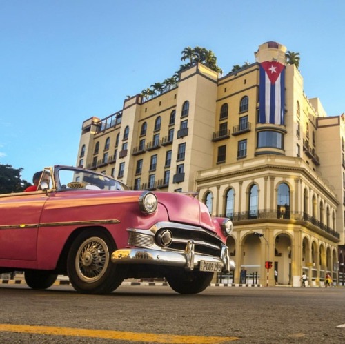 A classic convertible used to cart around tourists rolls down downtown Havana. Read more on Havanas 