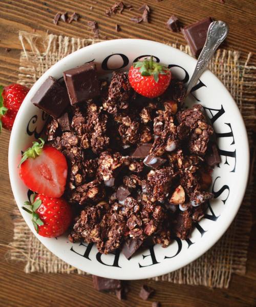 Chocolate and coconut granola, served with almond milk and strawberries.