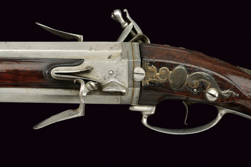 A double barrel over and under swivel barrel flintlock shotgun  signed “Cousin au Chateau de R