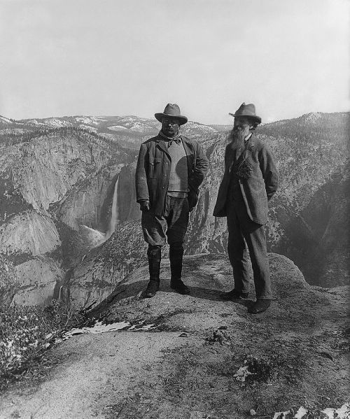 Theodore Roosevelt and John Muir stand on Glacier Point in Yosemite National Park.