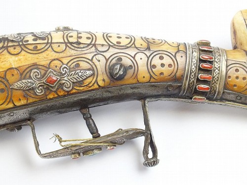 A North African snaphaunce musket mounted with ivory and decorated with silver, turquoise, and red c