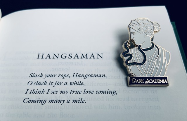 The opening page of Shirley Jackson's novel HANGSAMAN (1951) with a Dark Academia pin depicting a snake coiling around a classical bust.