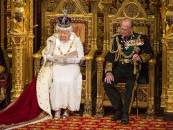noislandofdreams: A photo of the queen talking about poverty whilst sat on a gold chair and wearing a hat made of jewels 