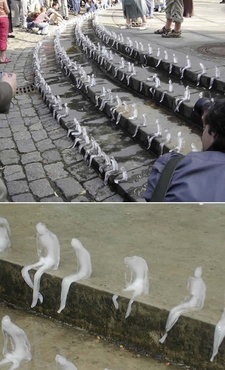 awesome Art installation with hundreds of little frozen men, left out to melt in