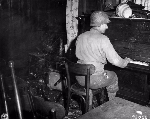 operationbarbarossa: Pfc. R. Larock of E. Co., 119th IR, 30th Infantry Division, relaxes after a day