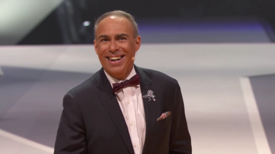 prince-of-eros:  snickerdoodle-writes:  So is no one gonna talk about how Darin de Paul (voice of Reinhardt) came out on stage at Blizzcon in a tuxedo and wearing a Reinhardt pin while tossing candy to the audience and almost cried while speaking because