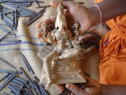 Sthapati (deity sculptor) hands and Lakshmi murti