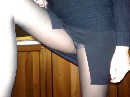 Flashing housewife in black pantyhose showing panties under skirt. Woman in pantyhose