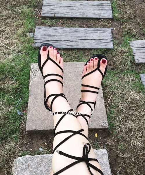Lovely lace up gladiator sandals on pretty feet.