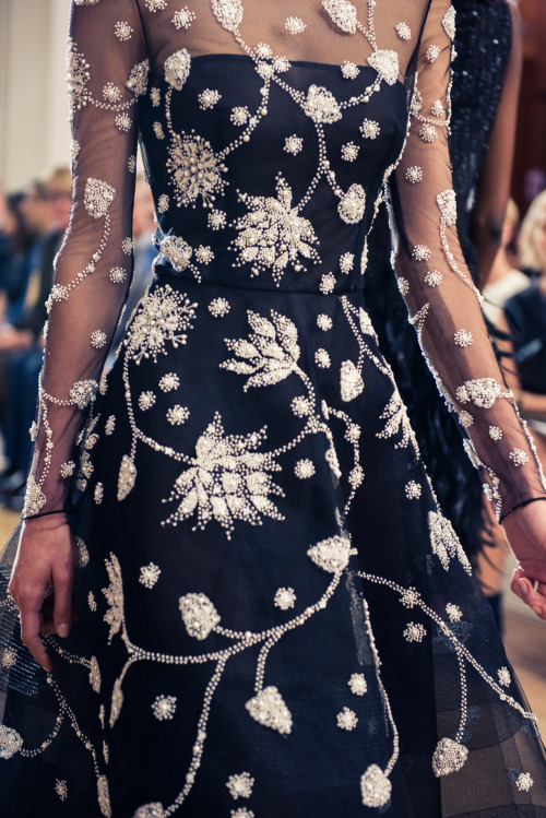 Thousands of pearls are hand-embroidered on black tulle to create a breathtaking lotus motif. Photo 