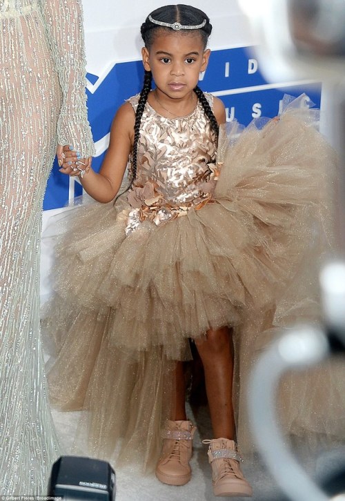 Is Beyonce trying to pass off her little boy as a little girl?  Does not anyone else see that this is a little boy dressed up in a dress? Beyonce needs to go to prison for child abuse, imagine how screwed up this little boy is going to be when he gets