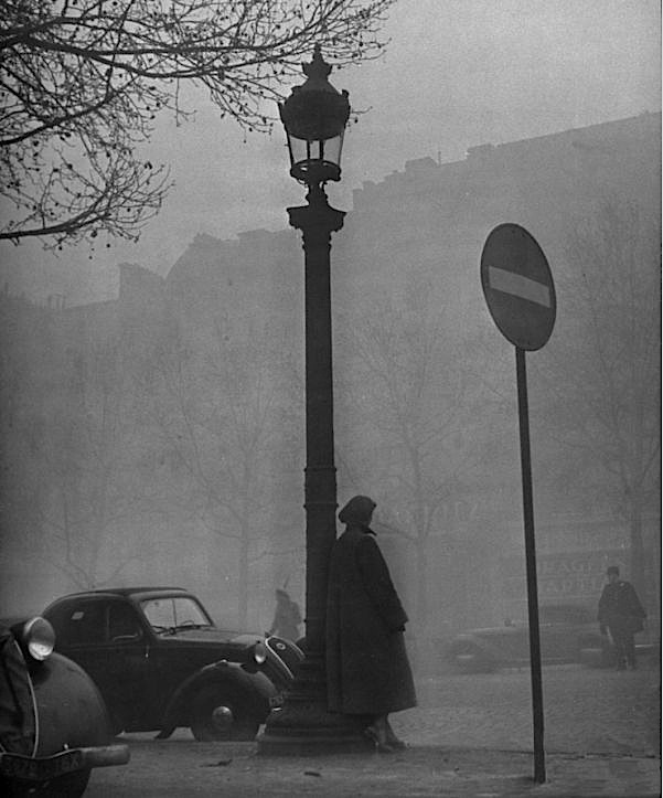 Yale Joel. People and vehicles moving about city shrouded in fog, Paris, 1948. From LIFE Images