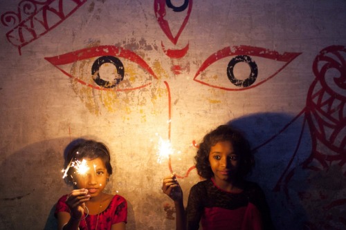 Children play with sparklers during Diwali festival in Dhaka, Bangladesh on October 23, 2014. (KM As