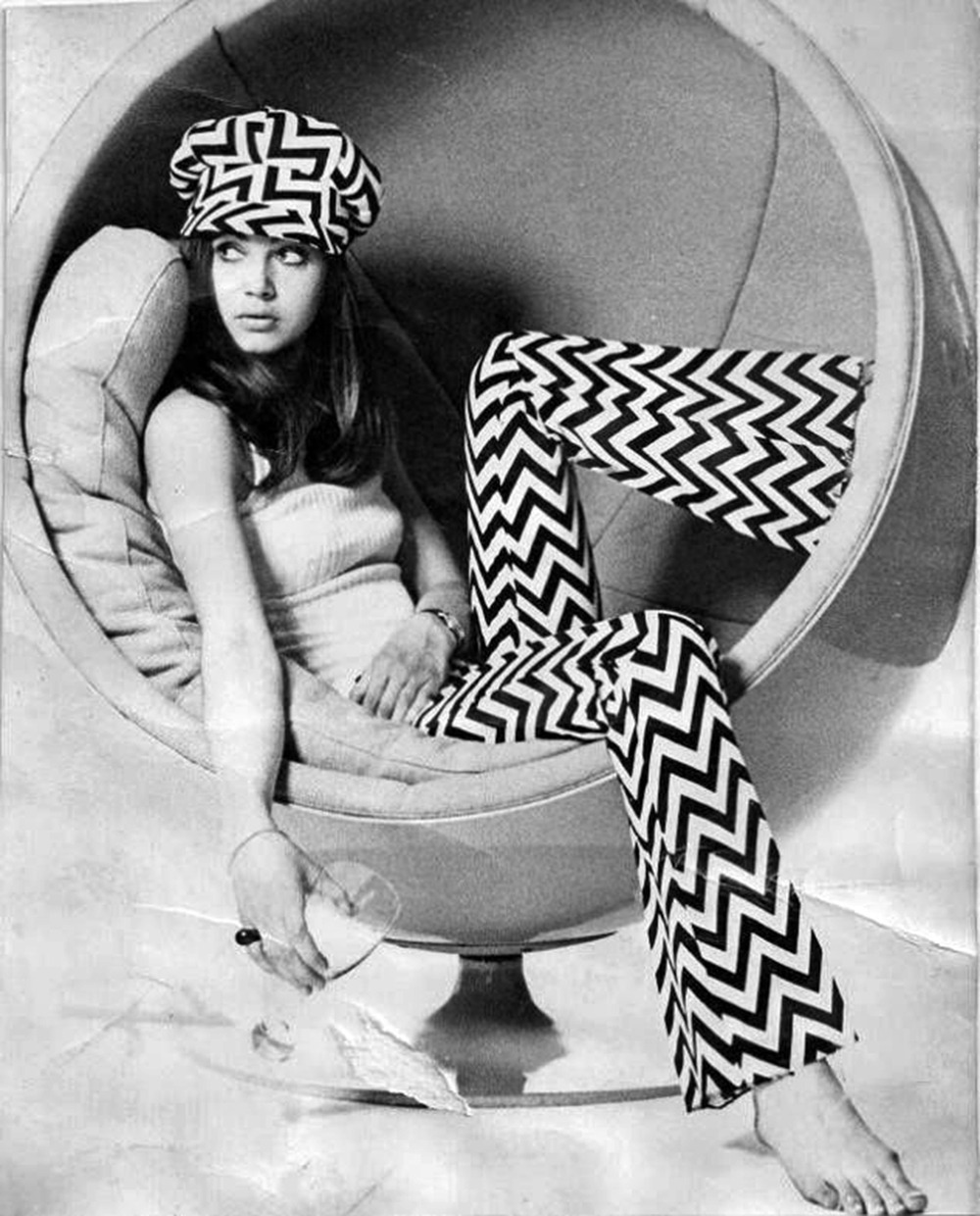 mangodebango: Model wearing chevron bell-bottom pants &amp; cap sitting in an