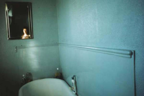 woundgallery:  Nan Goldin, Self-portrait in blue bathroom, London 1980