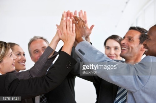 Business Group Congratulating Each Other With Group High Five - stocknroll