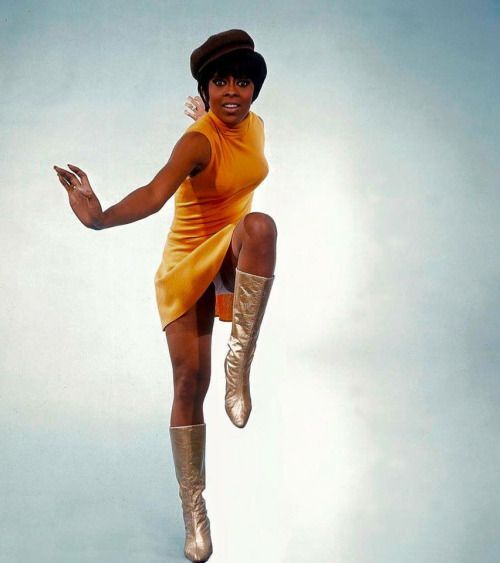 Wearing a close-fitting dress, a hat and gilded boots, the lively American show girl Lola Falana, bo